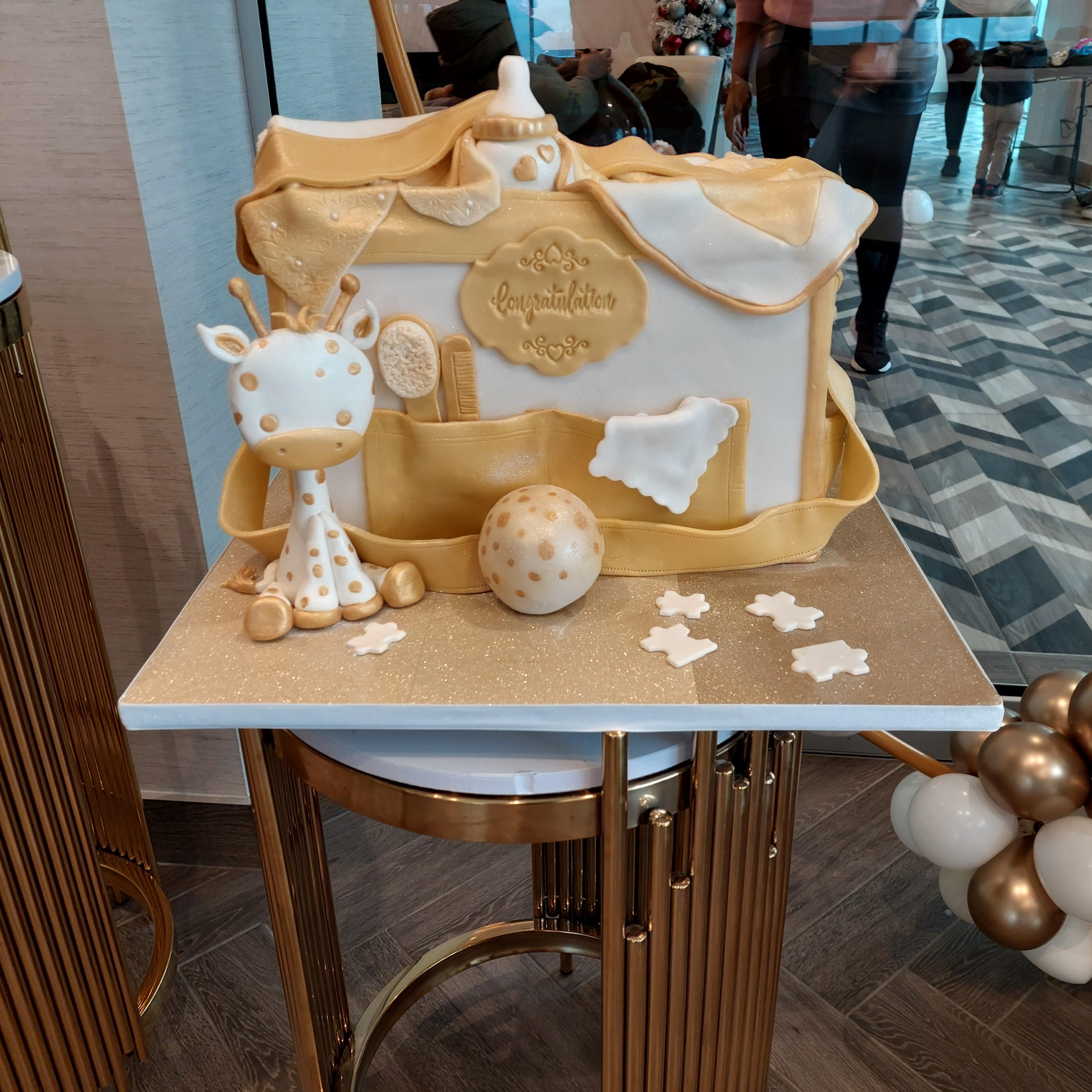 Baby bag with small giraffe toy and ball in front of the bag.